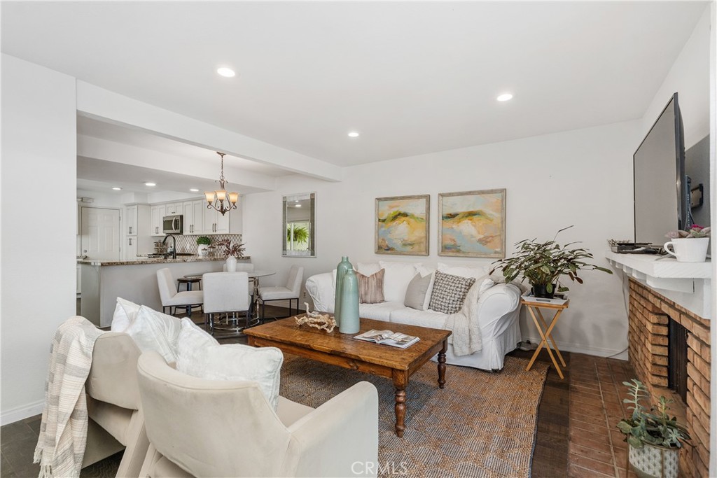 1041 Tustin Pines Way Tustin, CA 92780 - Photo 6 of 32 a living room with furniture a flat screen tv and kitchen view