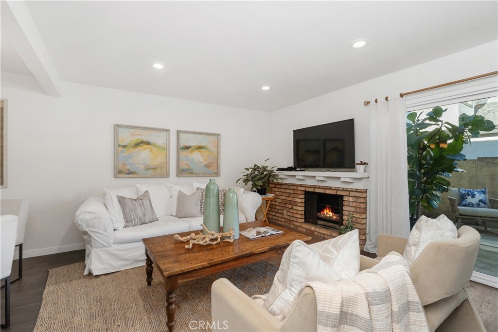 1041 Tustin Pines Way Tustin, CA 92780 - Photo 8 of 32 a living room with furniture a fireplace and a flat screen tv