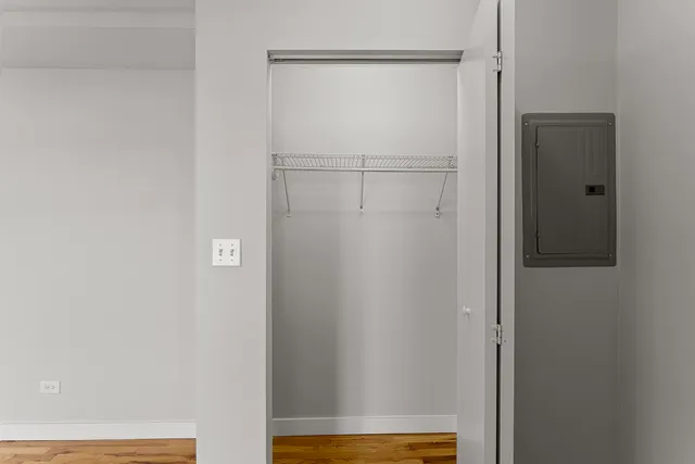 a view of walk in closet with empty racks
