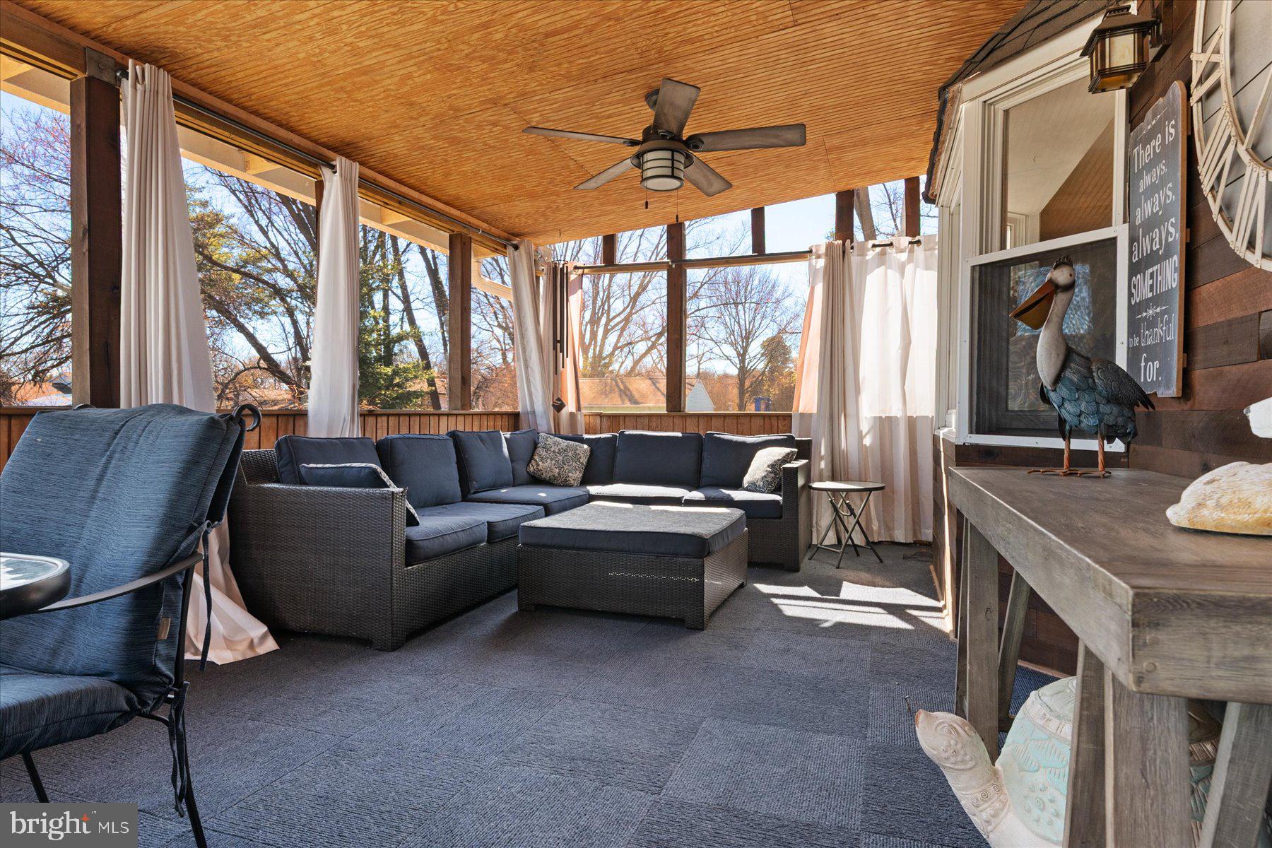 7801 Harle Road Pasadena, MD 21122 - Photo 25 of 64 a living room with furniture a fireplace and a large window