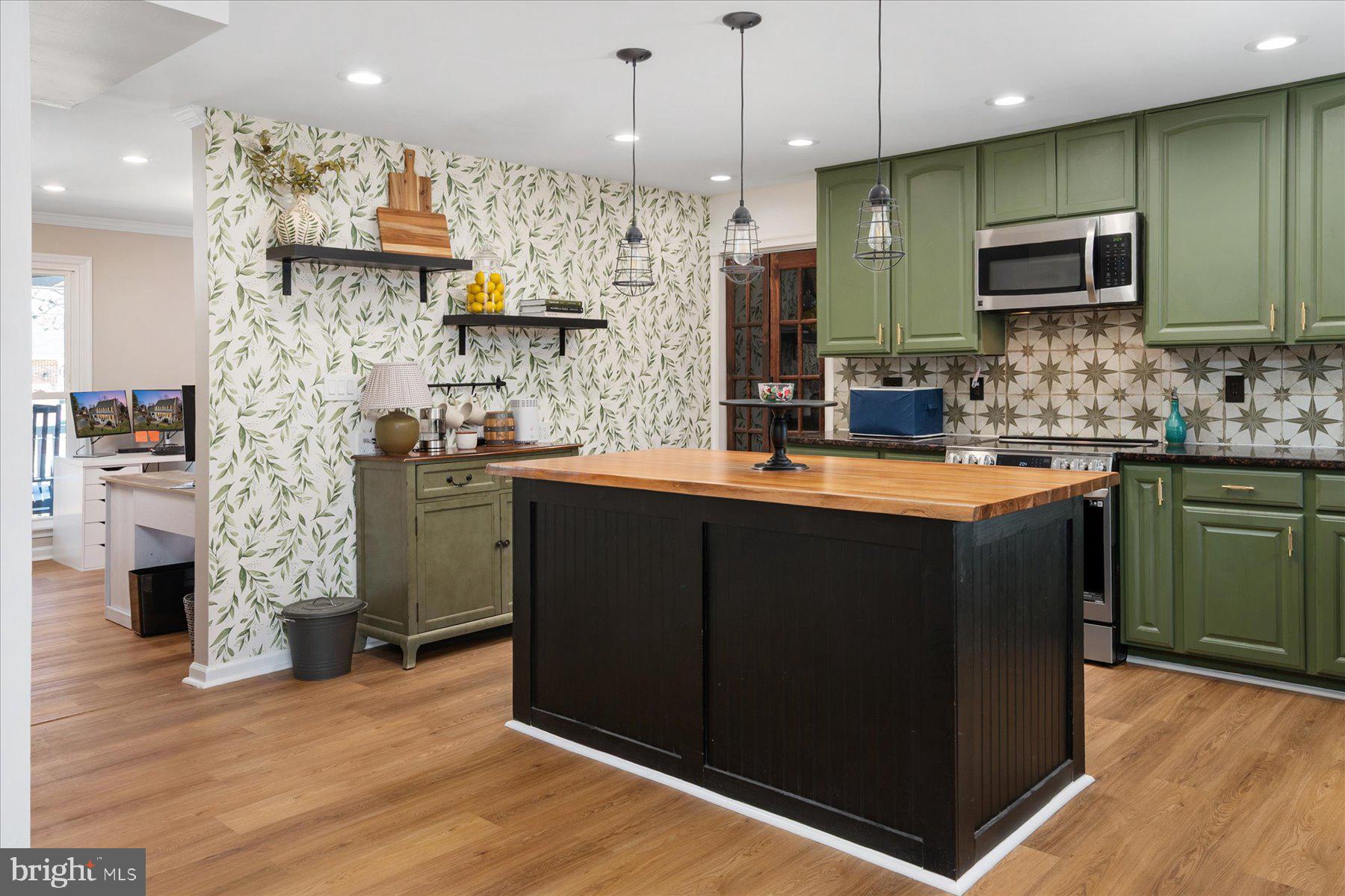 7801 Harle Road Pasadena, MD 21122 - Photo 27 of 64 a kitchen with stainless steel appliances granite countertop a sink a stove and a wooden floors