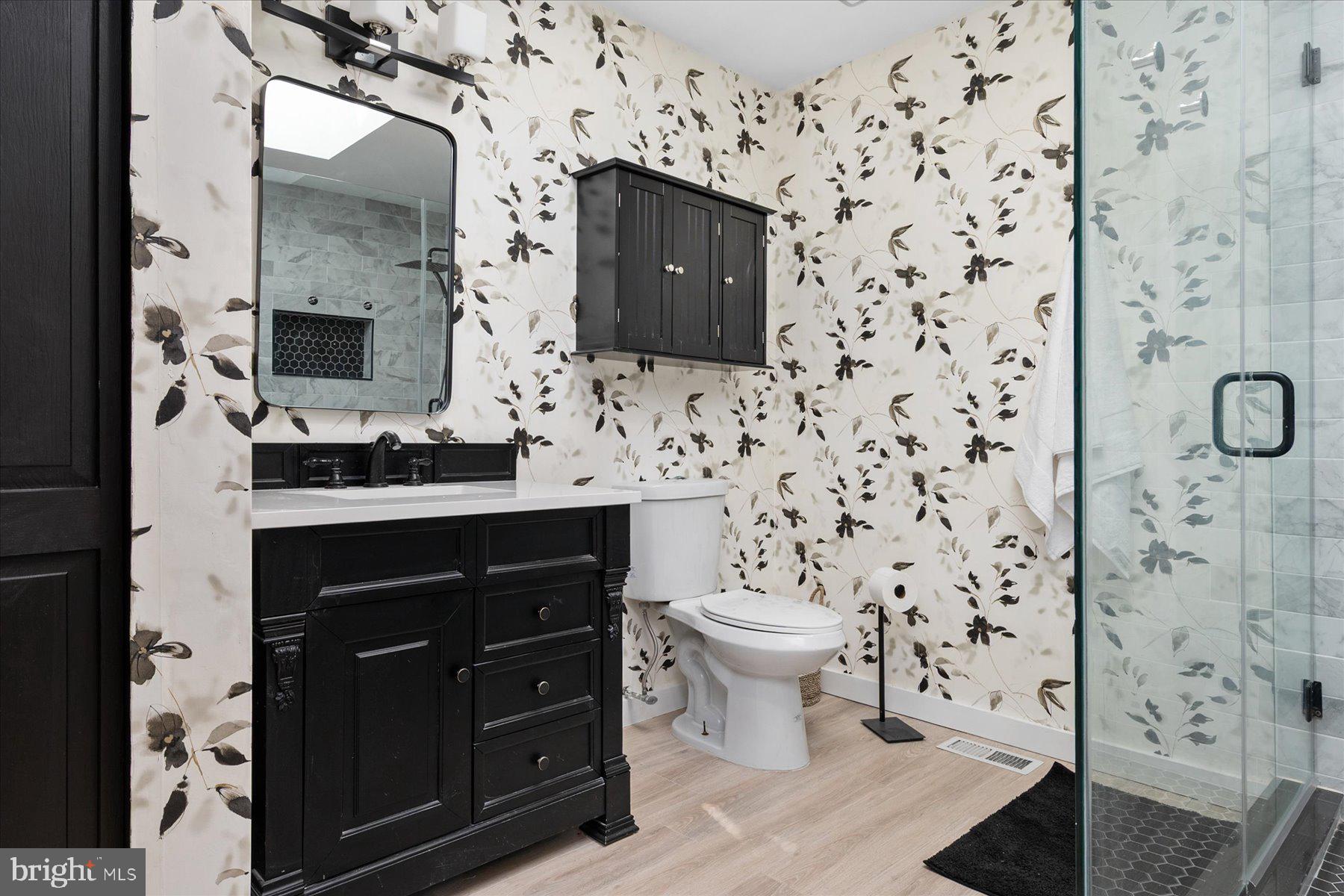 7801 Harle Road Pasadena, MD 21122 - Photo 36 of 64 a bathroom with a sink and a mirror