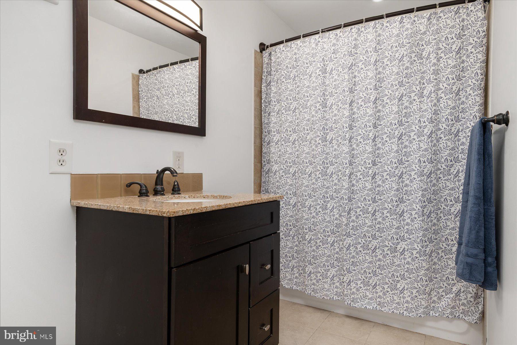 7801 Harle Road Pasadena, MD 21122 - Photo 46 of 64 a bathroom with a sink and mirror