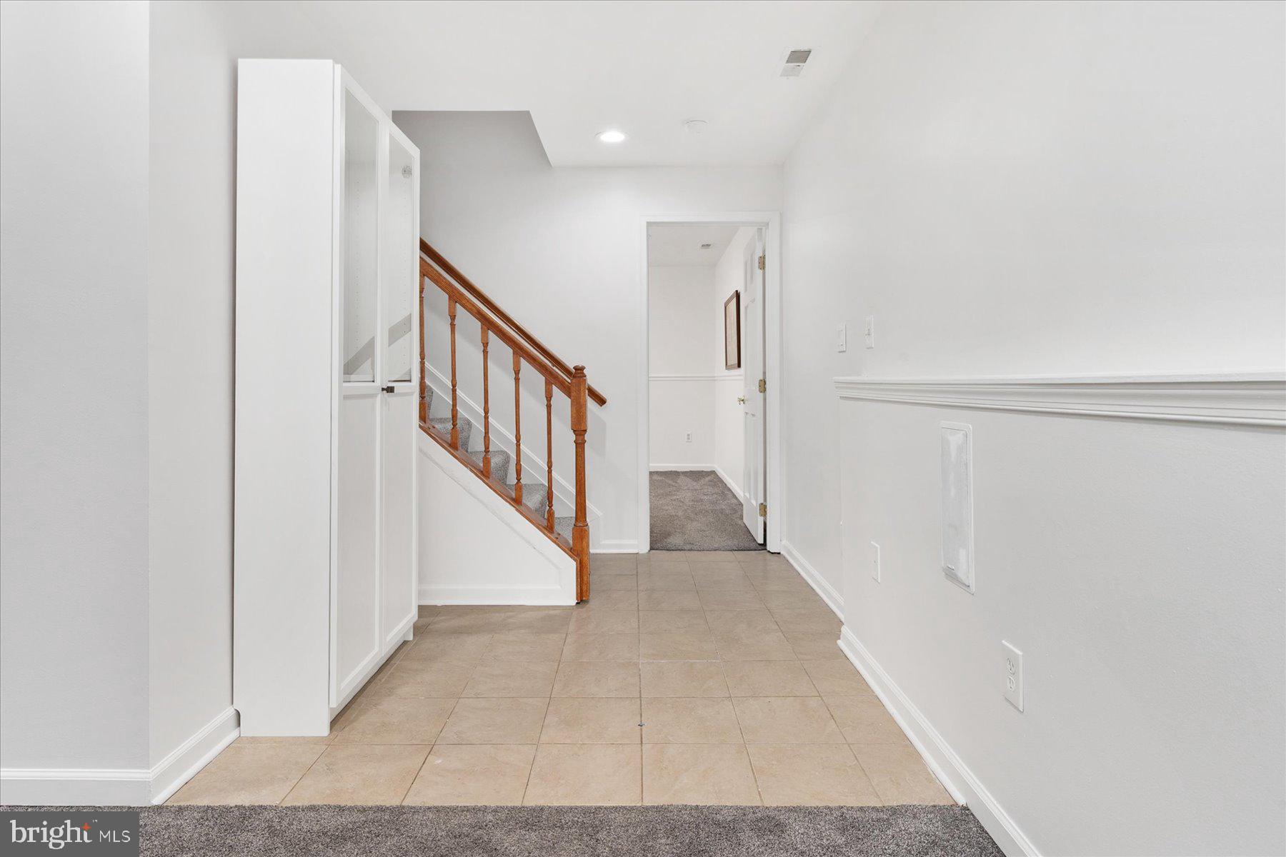 7801 Harle Road Pasadena, MD 21122 - Photo 47 of 64 a view of a hallway with wooden floor and staircase