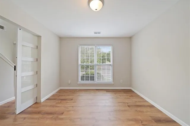 a bathroom with a toilet sink vanity and mirror