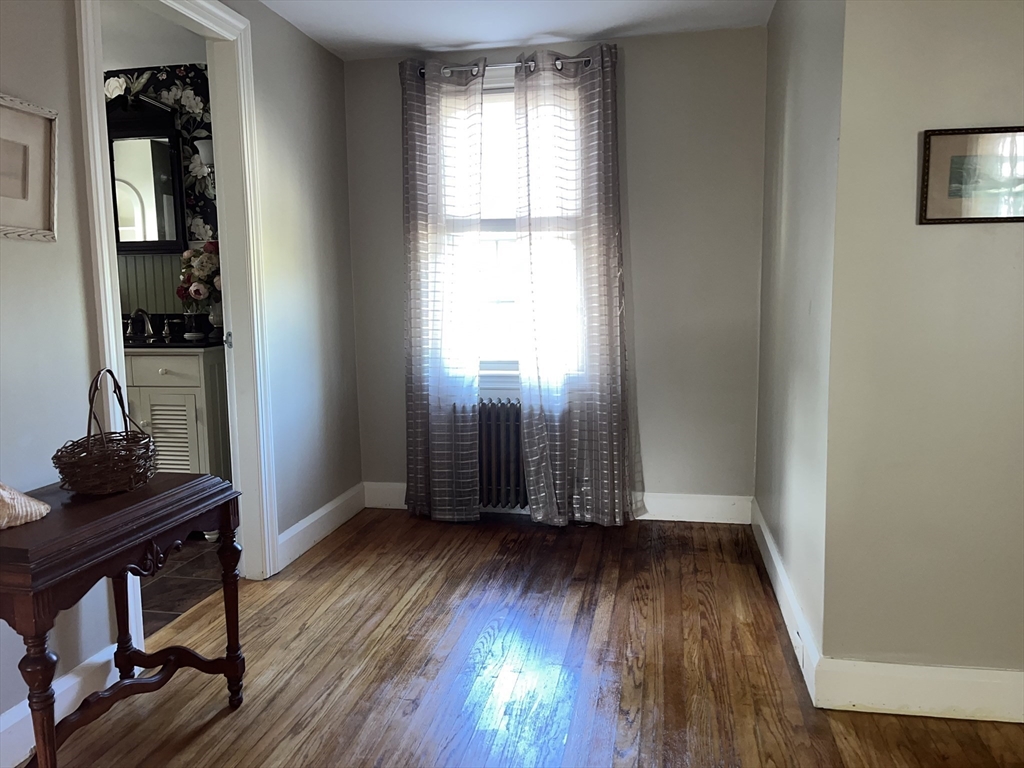 112 Chestnut Street Southbridge, MA 01550 - Photo 14 of 32 an empty room with wooden floor and windows