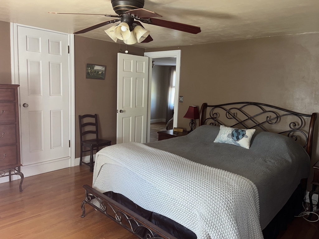 112 Chestnut Street Southbridge, MA 01550 - Photo 16 of 32 a bedroom with a bed and a chandelier