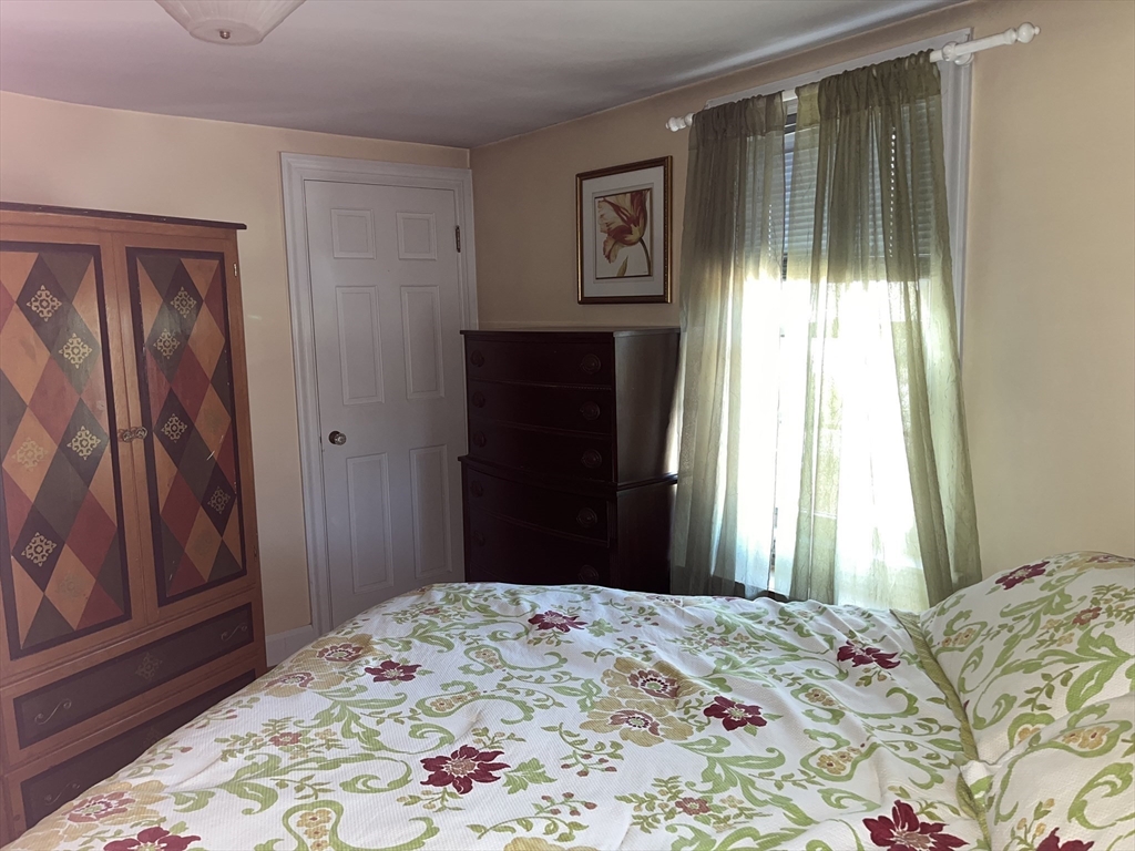 112 Chestnut Street Southbridge, MA 01550 - Photo 18 of 32 a bedroom with a bed and wooden floor