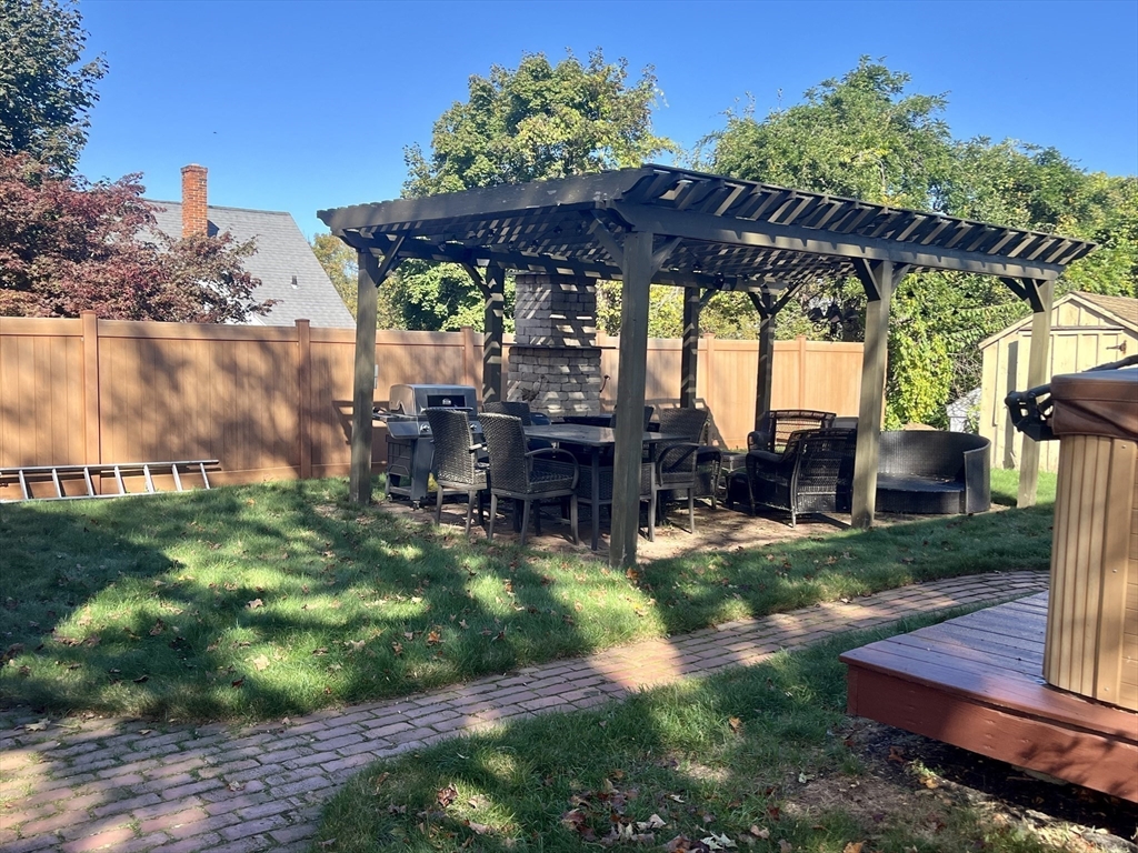 112 Chestnut Street Southbridge, MA 01550 - Photo 28 of 32 a view of a backyard with table and chairs under an umbrella with a small yard