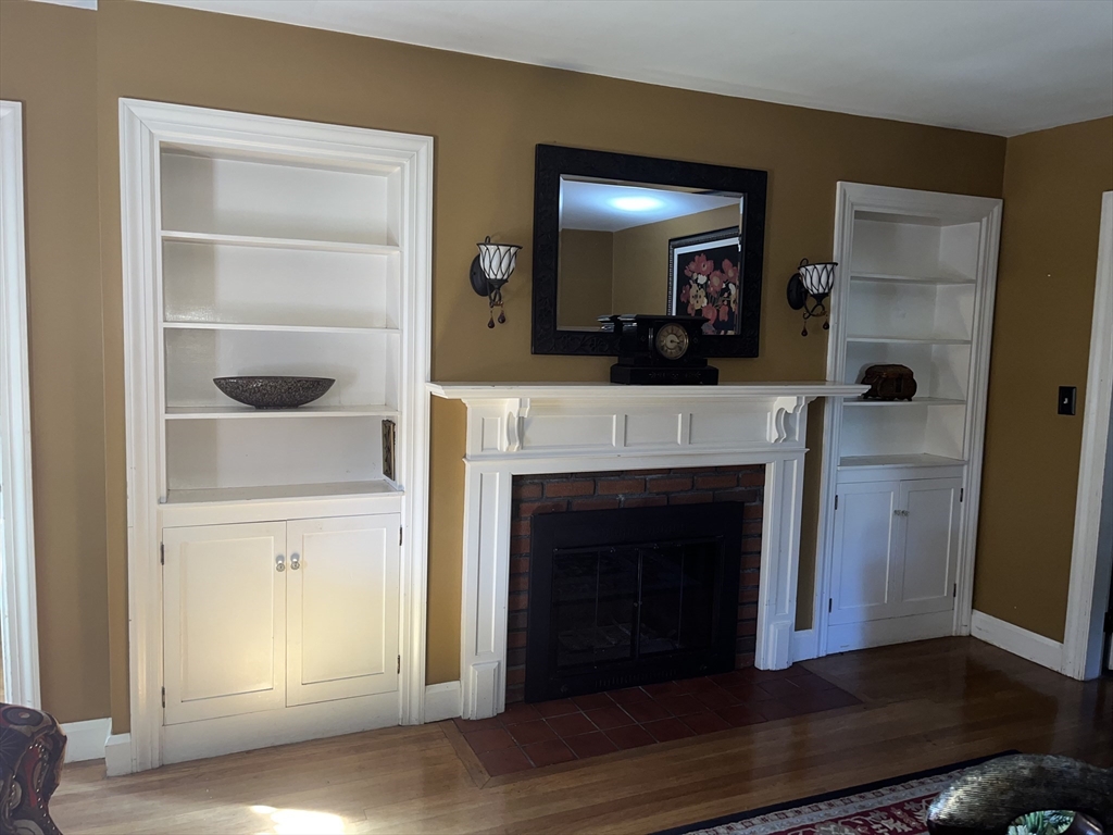 112 Chestnut Street Southbridge, MA 01550 - Photo 3 of 32 a living room with a fireplace and a mirror