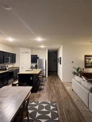 a large kitchen with a table and chairs in it