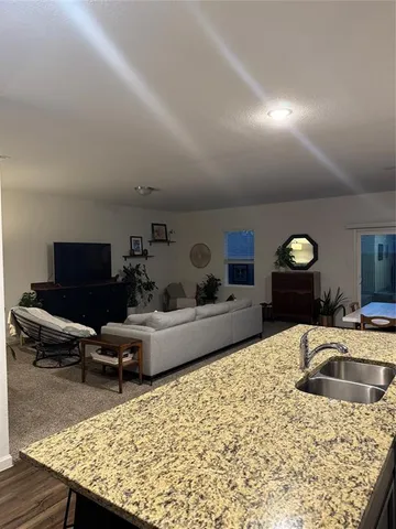 a view of a livingroom with wooden floor and workspace