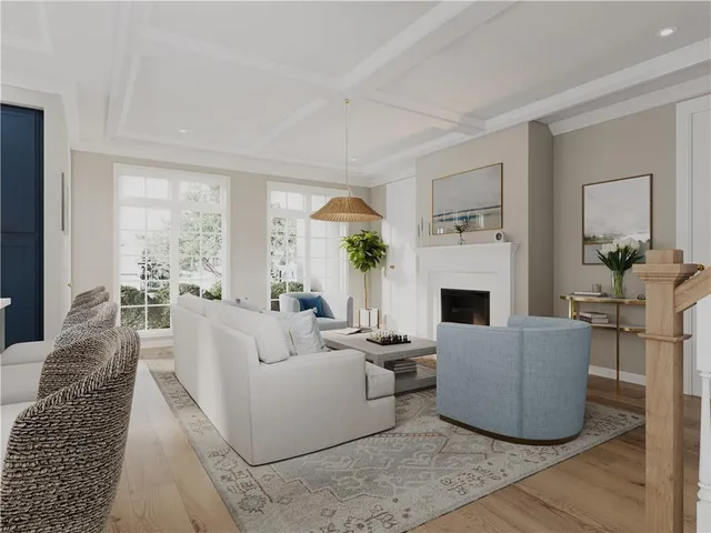 a living room with furniture a large window and a fireplace