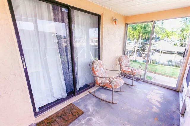 a living room with chairs and a floor to ceiling window