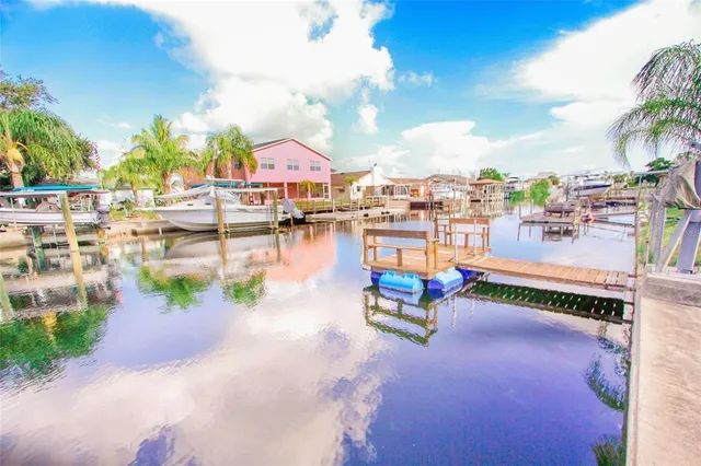 a view of a swimming pool with outdoor seating