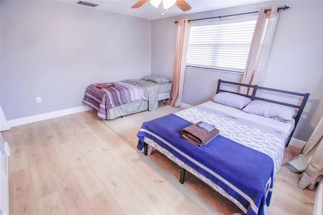 a bedroom with two beds and a chandelier
