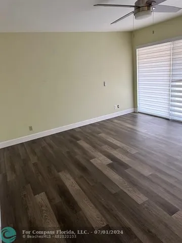 an empty room with wooden floor