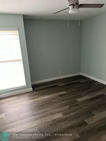 a view of room with window and hardwood floor