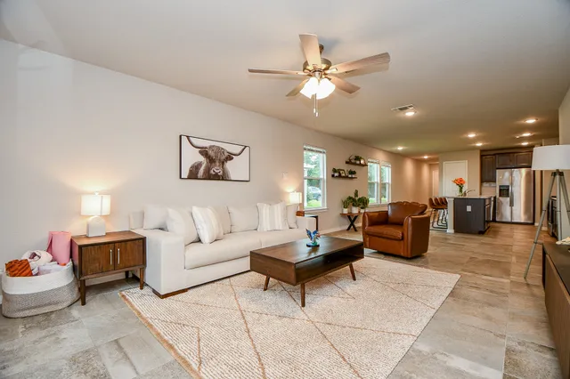 a living room with furniture and a chandelier