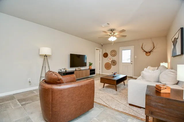 a living room with furniture and a flat screen tv