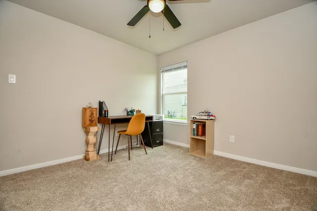 an empty room with furniture and a window