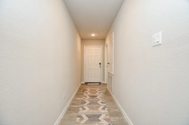 a view of hallway with wooden floor