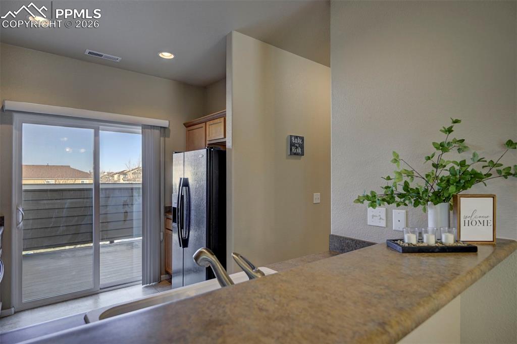 5653 Saint Patrick View Colorado Springs, CO 80923 - Photo 15 of 43 Balcony leading from kitchen to 2 person spa and mountain views.