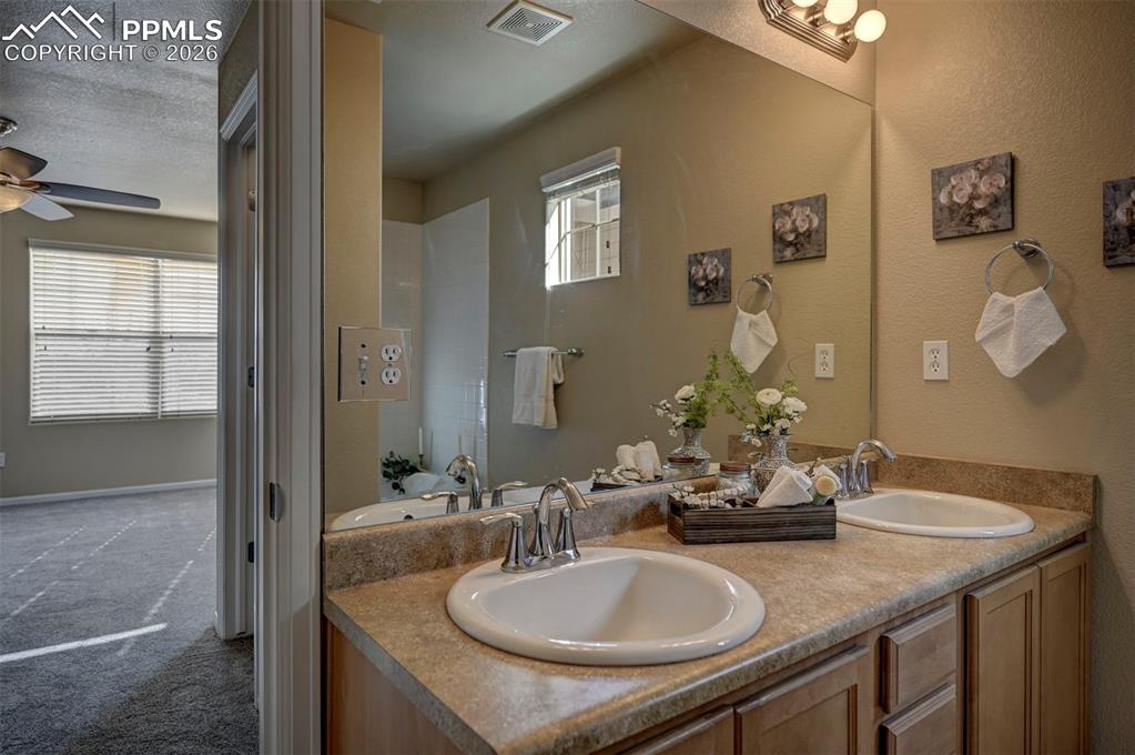 5653 Saint Patrick View Colorado Springs, CO 80923 - Photo 34 of 43 Attached primary bedroom full bathroom.