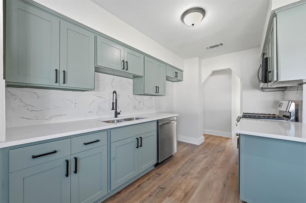 1016 Calcutta Street Hurst, TX 76053 - Photo 12 of 34 a kitchen with sink stove and cabinets