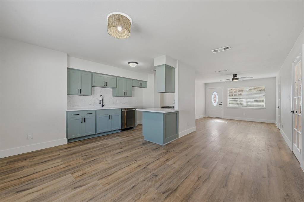 1016 Calcutta Street Hurst, TX 76053 - Photo 14 of 34 a view of a kitchen with wooden floor and a sink