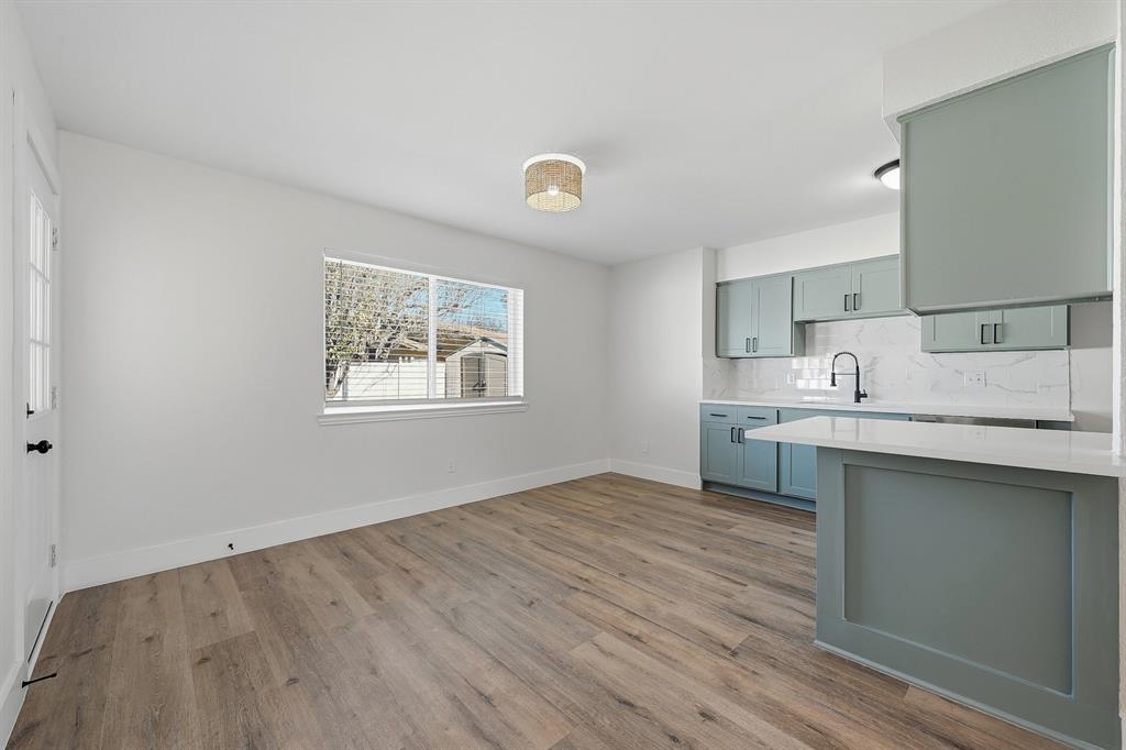 1016 Calcutta Street Hurst, TX 76053 - Photo 15 of 34 a kitchen with granite countertop a sink cabinets and wooden floor