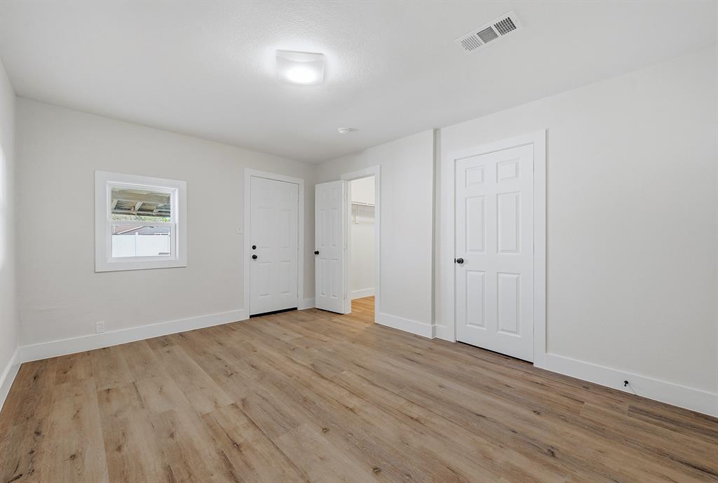 1016 Calcutta Street Hurst, TX 76053 - Photo 17 of 34 a view of an empty room with wooden floor and a window