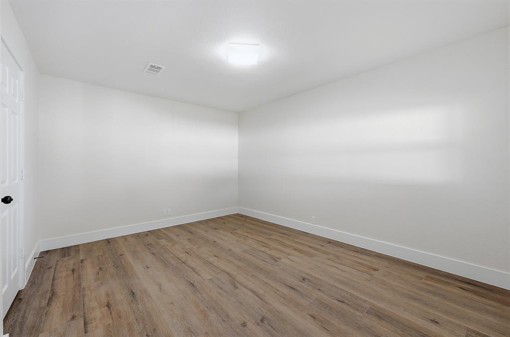 1016 Calcutta Street Hurst, TX 76053 - Photo 18 of 34 a view of an empty room with wooden floor