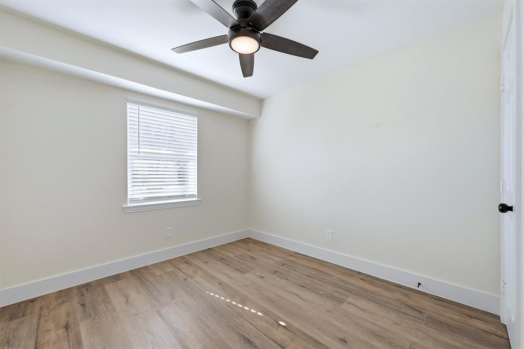 1016 Calcutta Street Hurst, TX 76053 - Photo 19 of 34 wooden floor in an empty room with a window