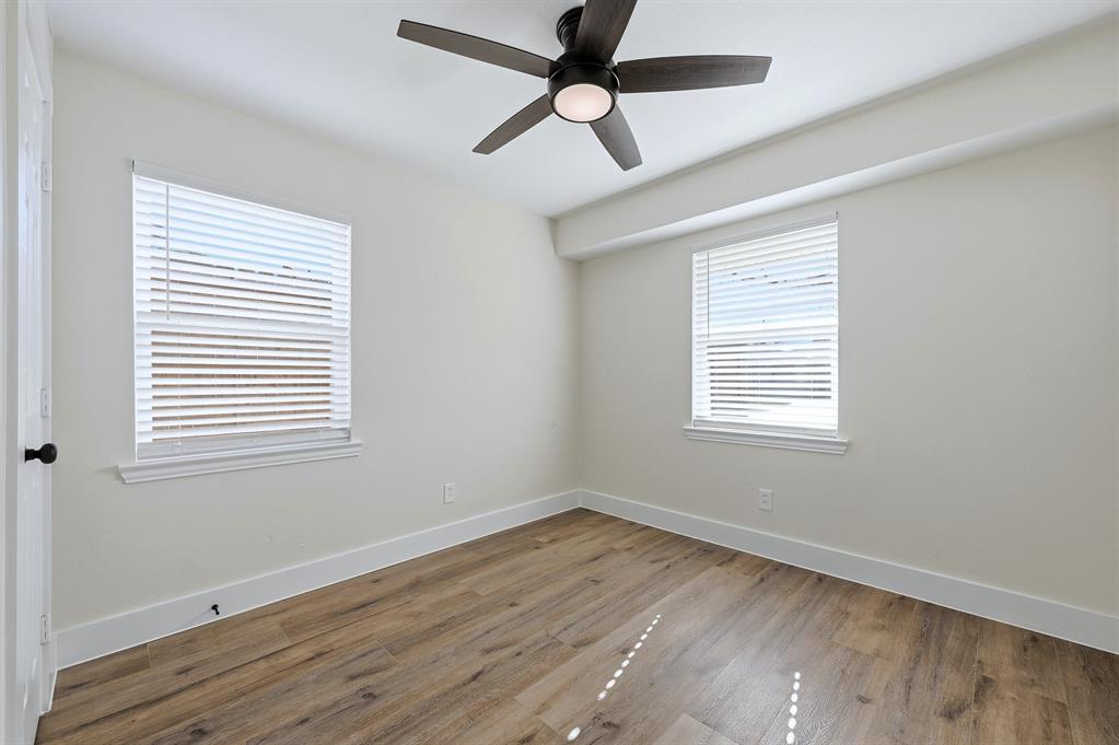 1016 Calcutta Street Hurst, TX 76053 - Photo 21 of 34 a view of an empty room with wooden floor and a window