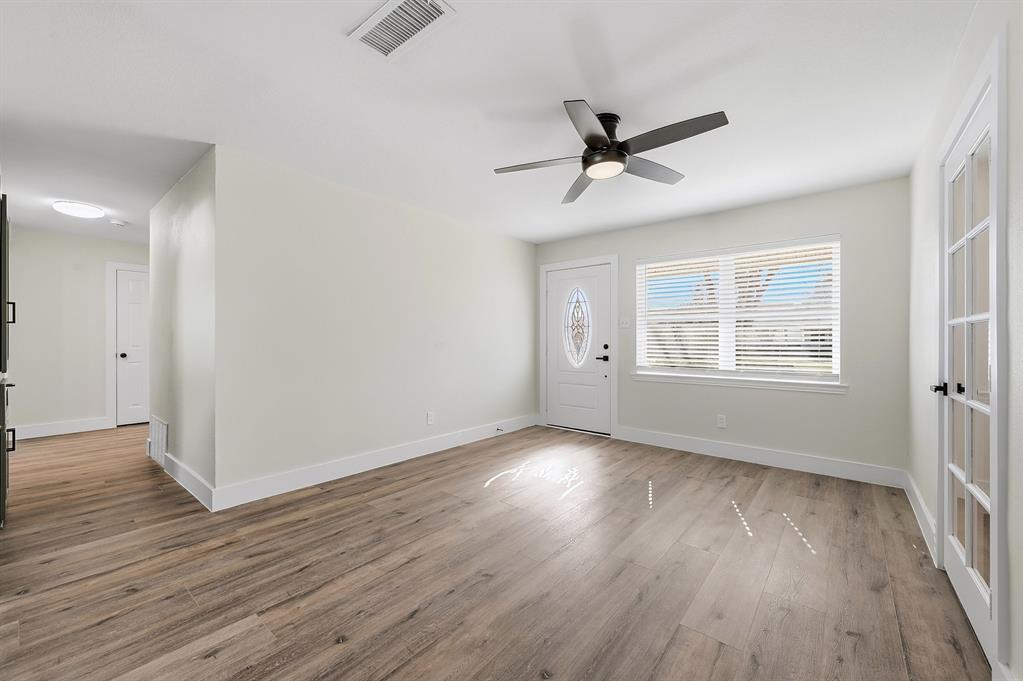 1016 Calcutta Street Hurst, TX 76053 - Photo 27 of 34 a view of an empty room with wooden floor and a window
