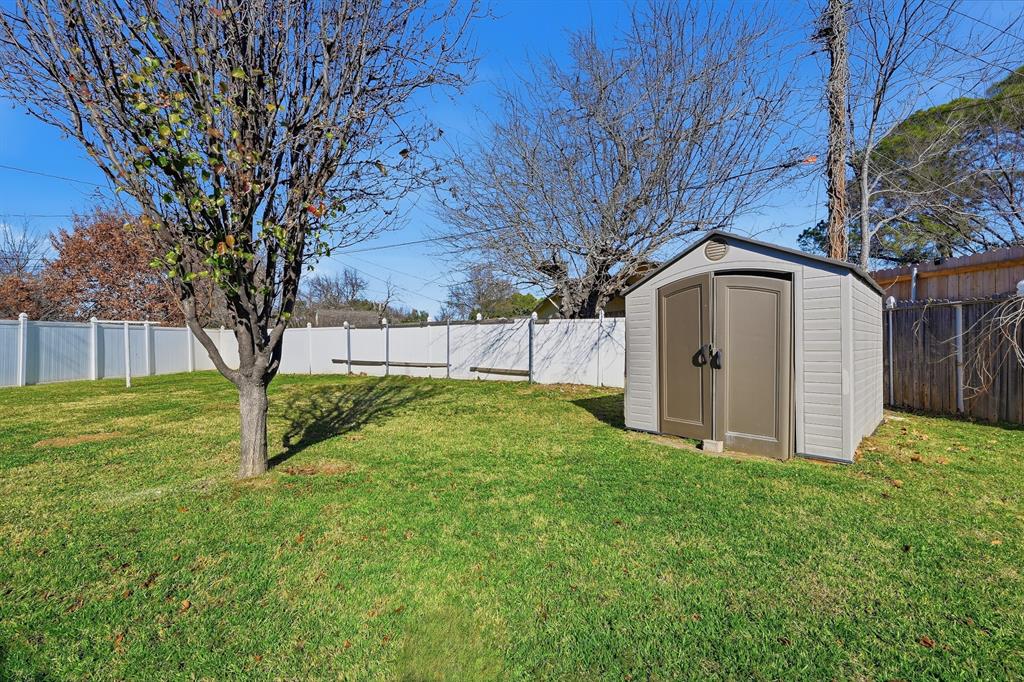 1016 Calcutta Street Hurst, TX 76053 - Photo 31 of 34 a view of backyard with barn and a large tree