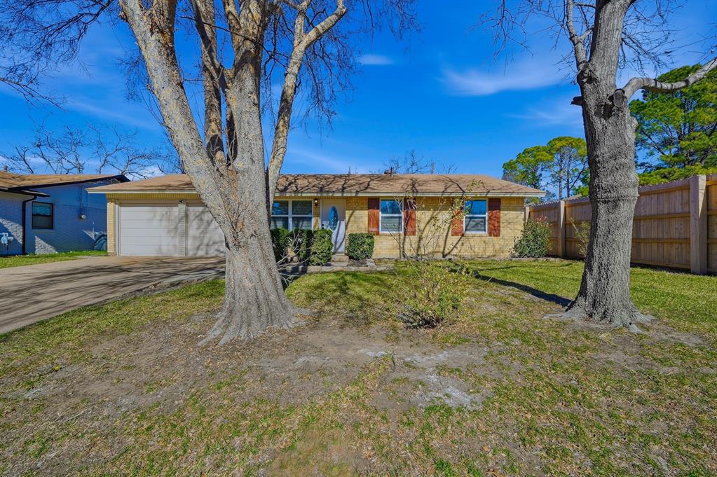 1016 Calcutta Street Hurst, TX 76053 - Photo 33 of 34 a view of a house with backyard and a tree