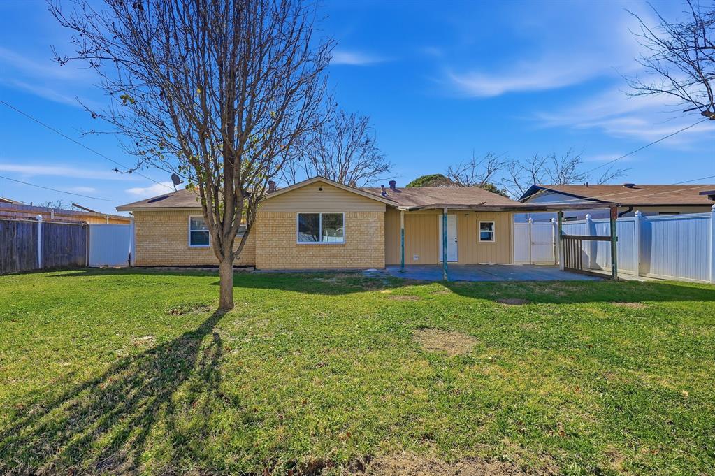1016 Calcutta Street Hurst, TX 76053 - Photo 5 of 34 a view of a house with a big yard and large tree