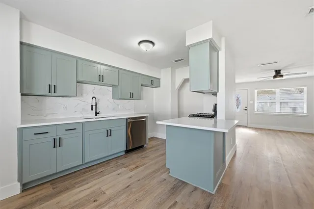 a kitchen with a sink stove and cabinets