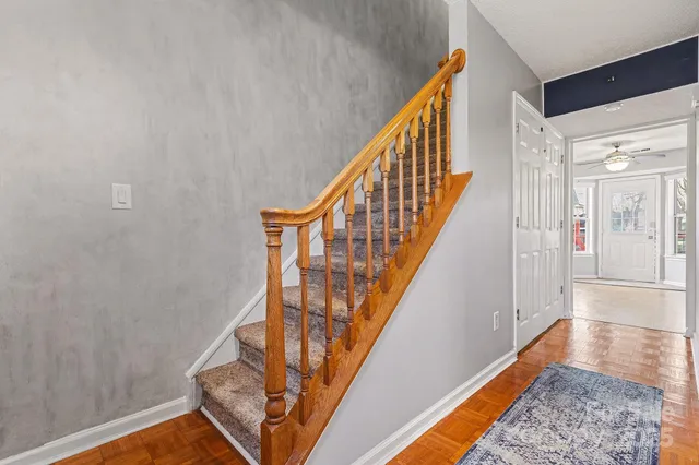 a view of entryway with wooden floor and stairs