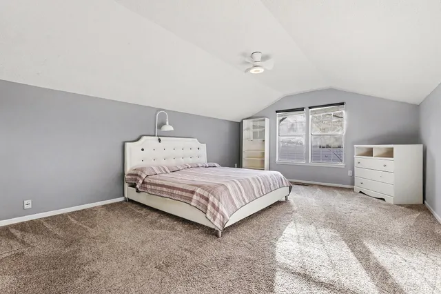 a spacious bedroom with a bed and a window