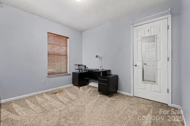 a view of workspace with furniture and window