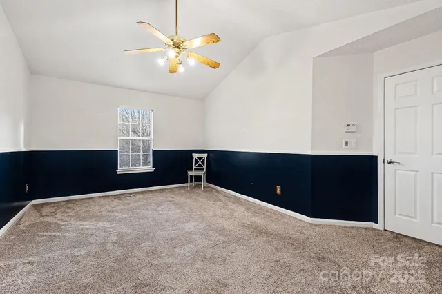 a bedroom with a cabinet and a ceiling fan
