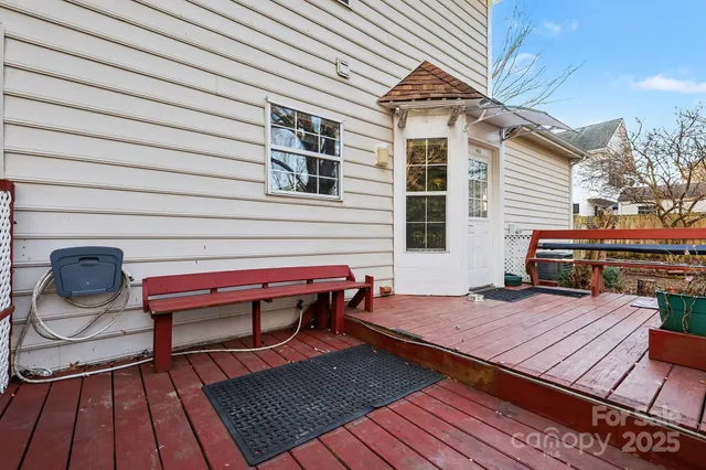 a backyard of a house with barbeque oven table and chairs