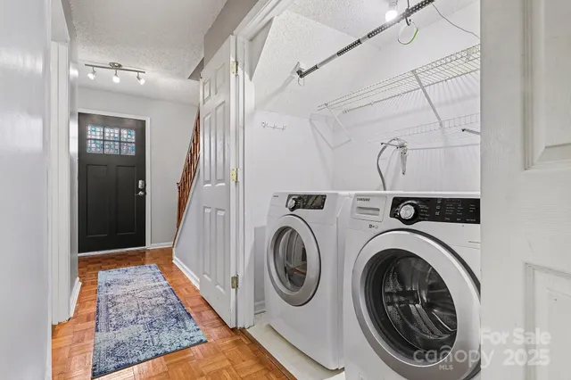 a view of a hallway with washer and dryer