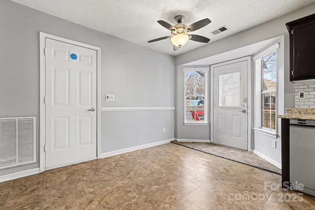 an empty room with closet and windows