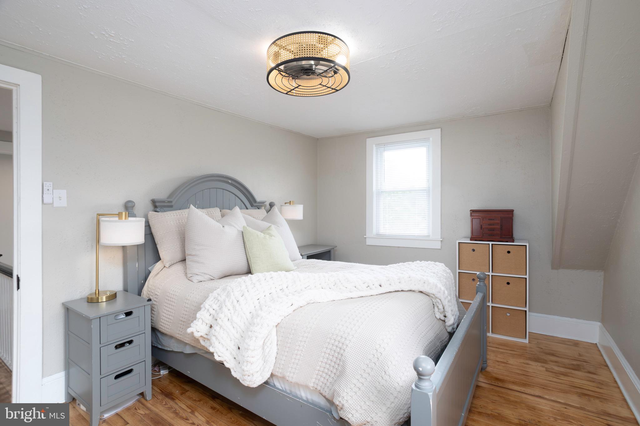 529 North 6th Street Denton, MD 21629 - Photo 17 of 21 a bedroom with a bed and a chandelier