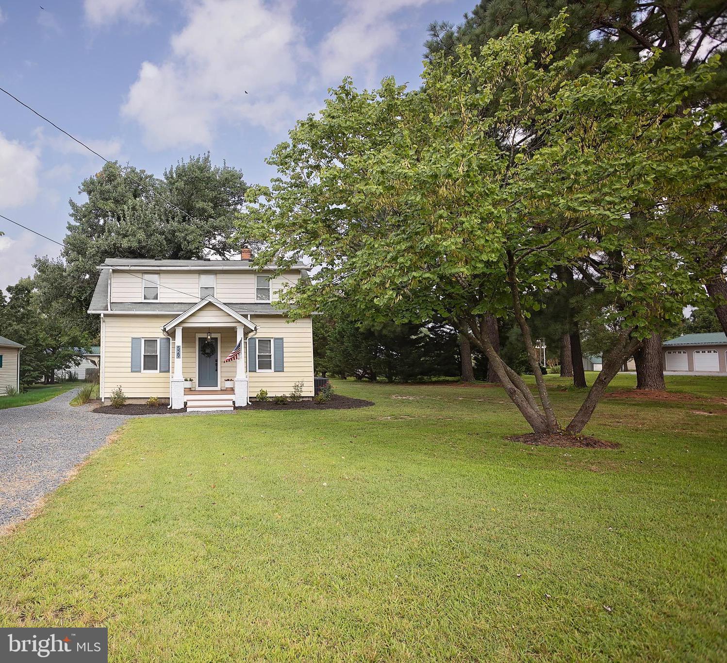 529 North 6th Street Denton, MD 21629 - Photo 3 of 21 a front view of a house with a garden and trees