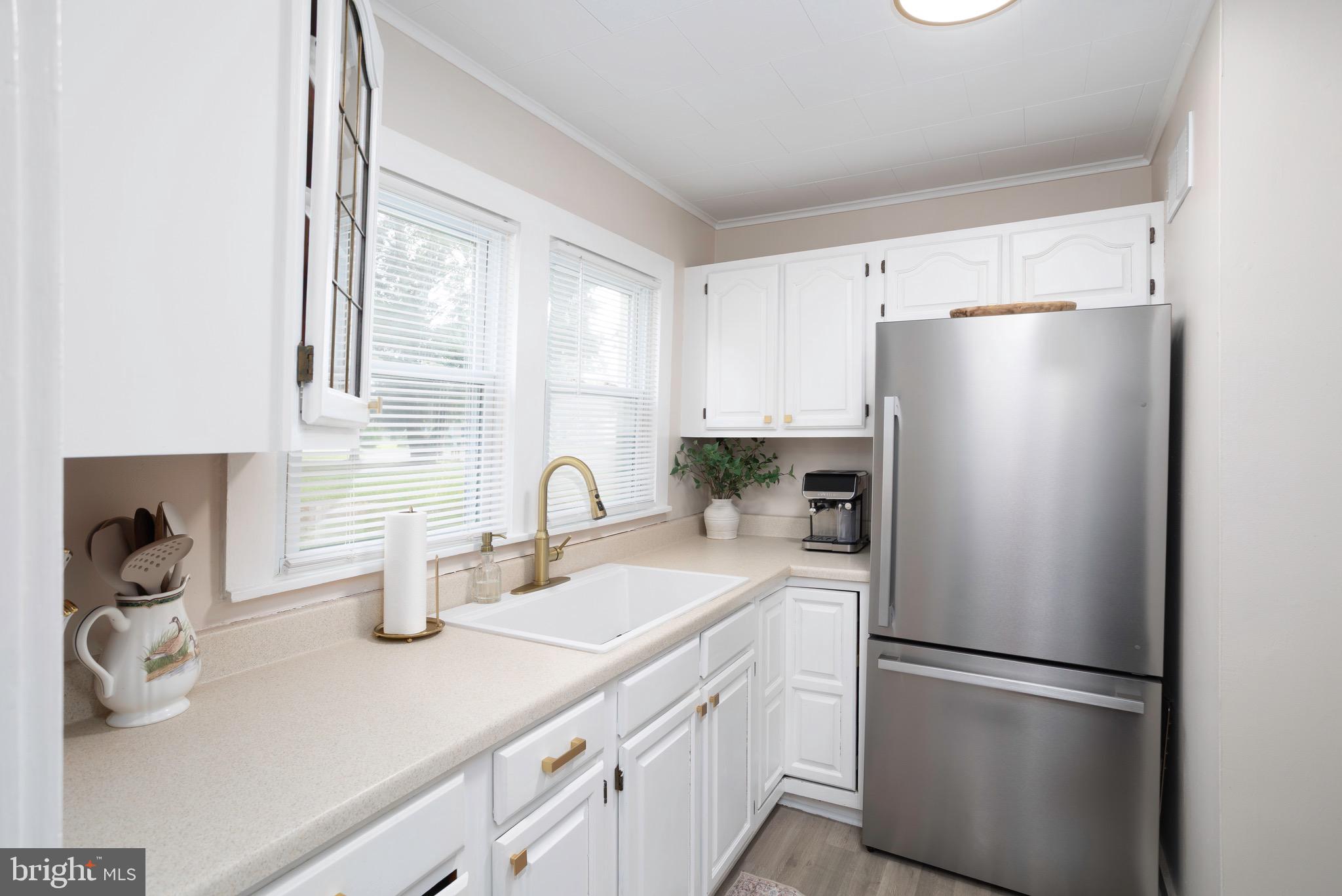 529 North 6th Street Denton, MD 21629 - Photo 8 of 21 a kitchen with a refrigerator and a sink